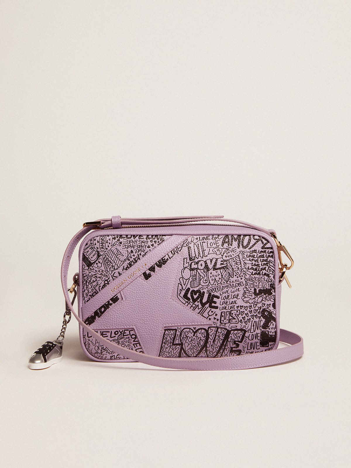 Borsa Star Bag in pelle martellata color lilla con stella in pelle ton sur ton e stampa graffiti all-over di colore nero