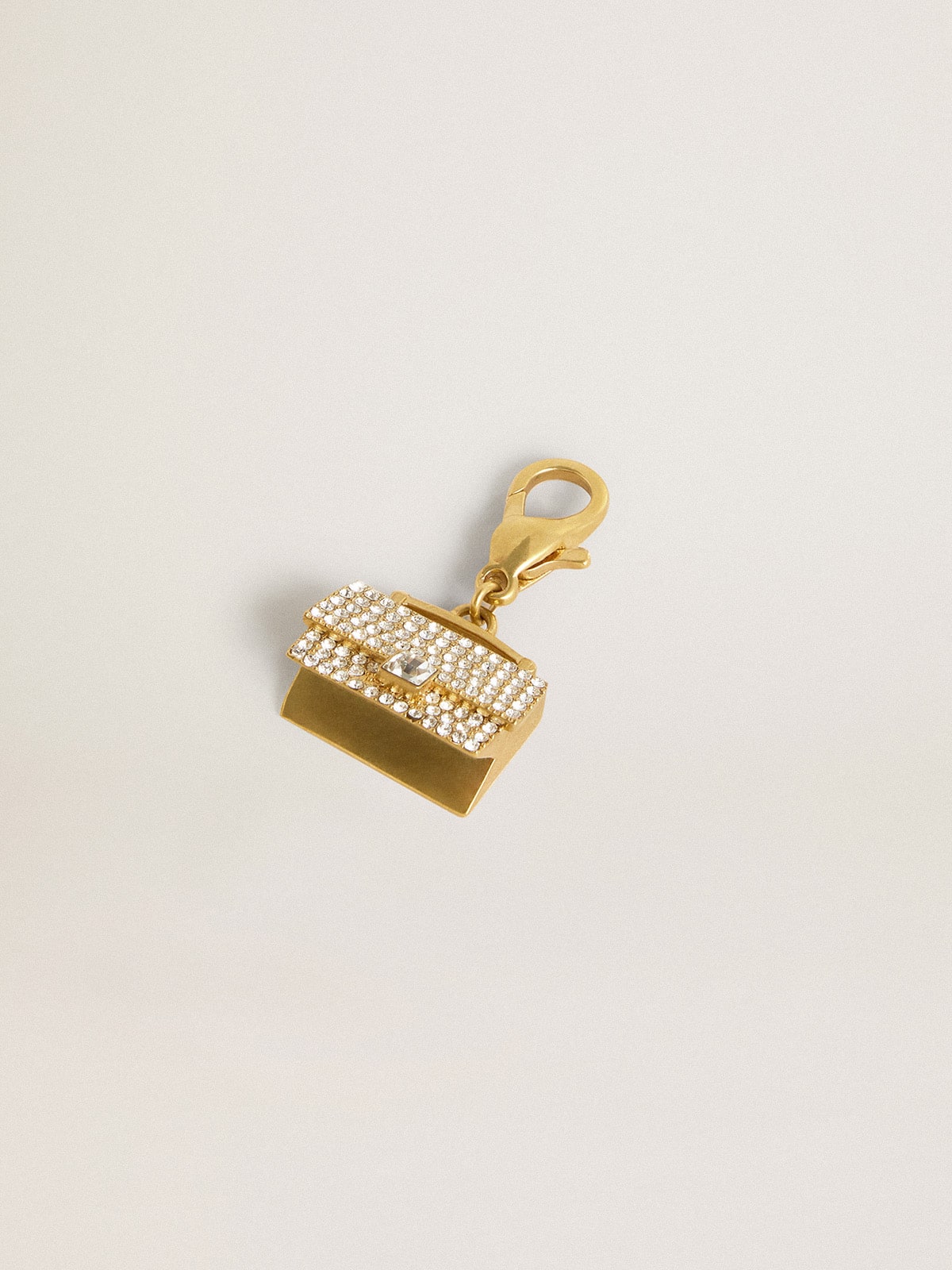 Purse-shaped charm in gold-colored brass with crystals