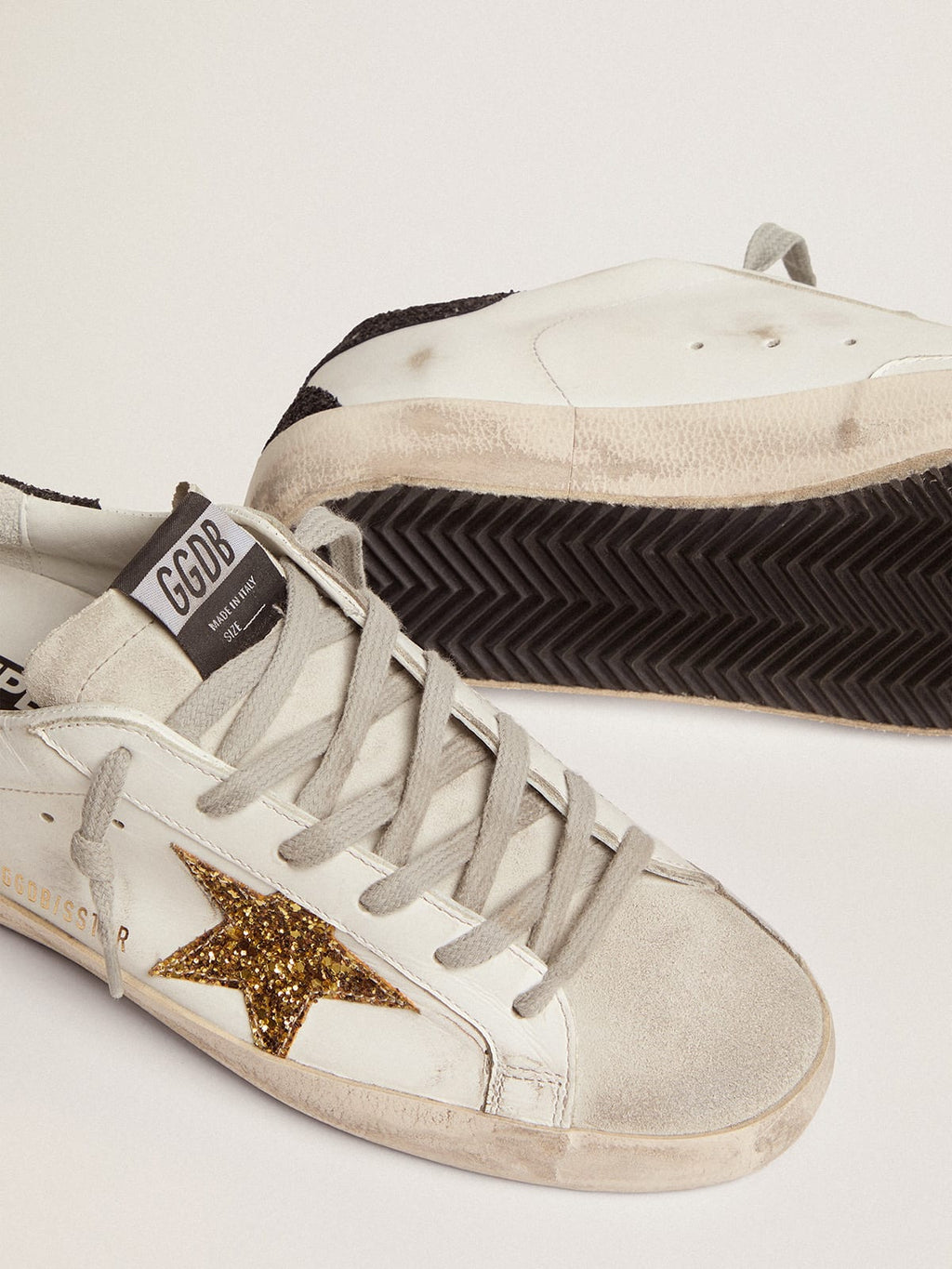 Sneakers Super-Star con stella dorata e talloncino nero in glitter