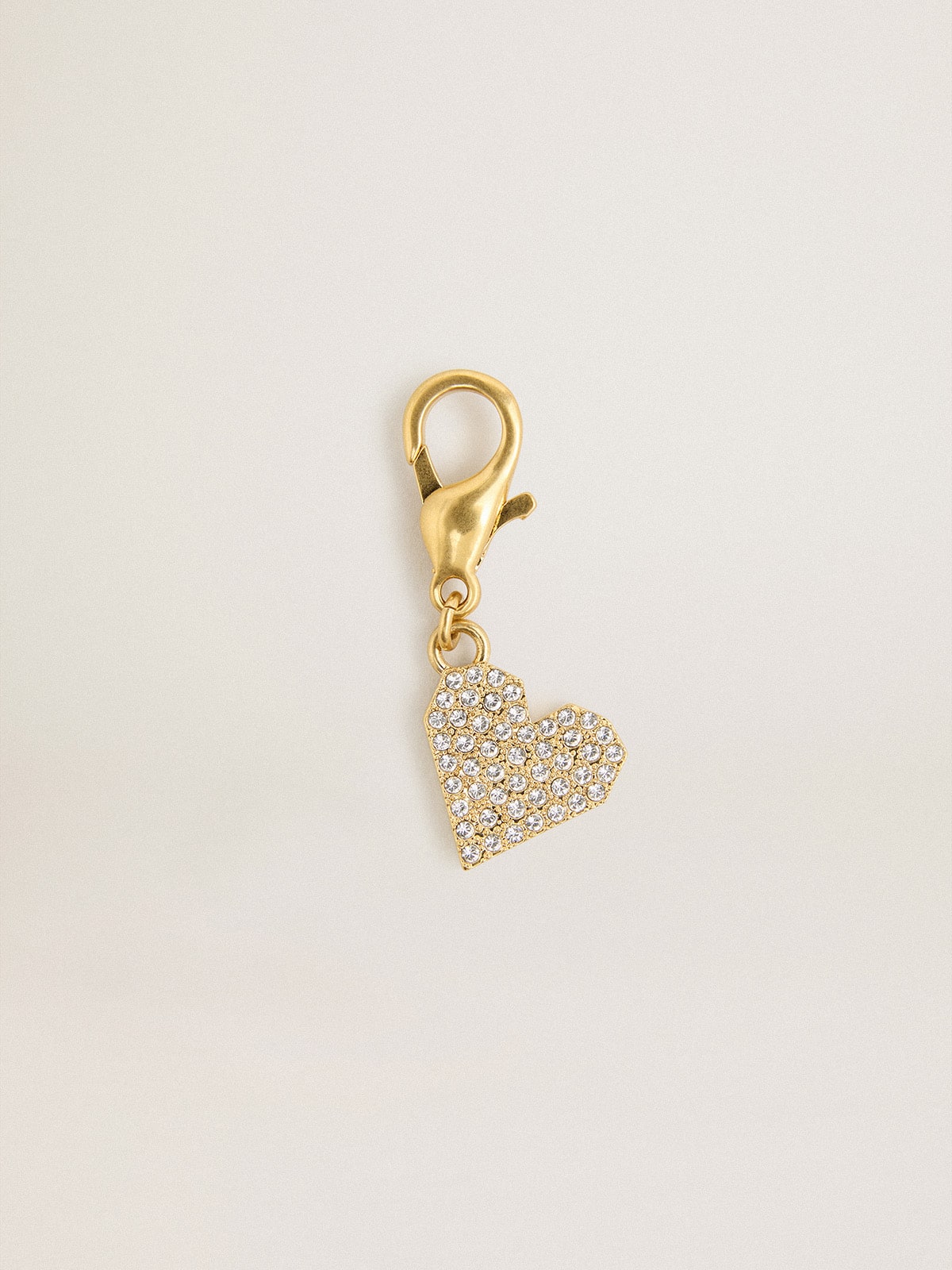 Heart-shaped charm in gold-colored brass with crystals