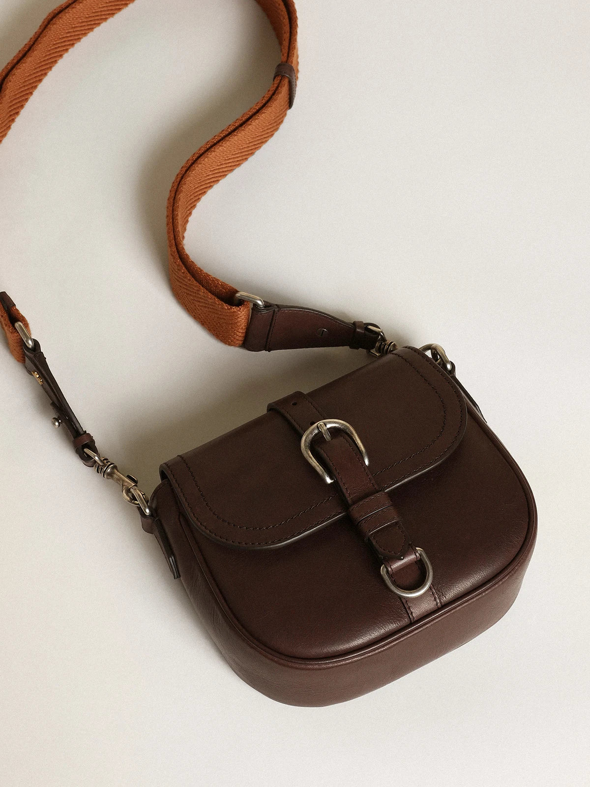 Borsa Sally Bag small in pelle color marrone scuro con fibbia e tracolla a contrasto