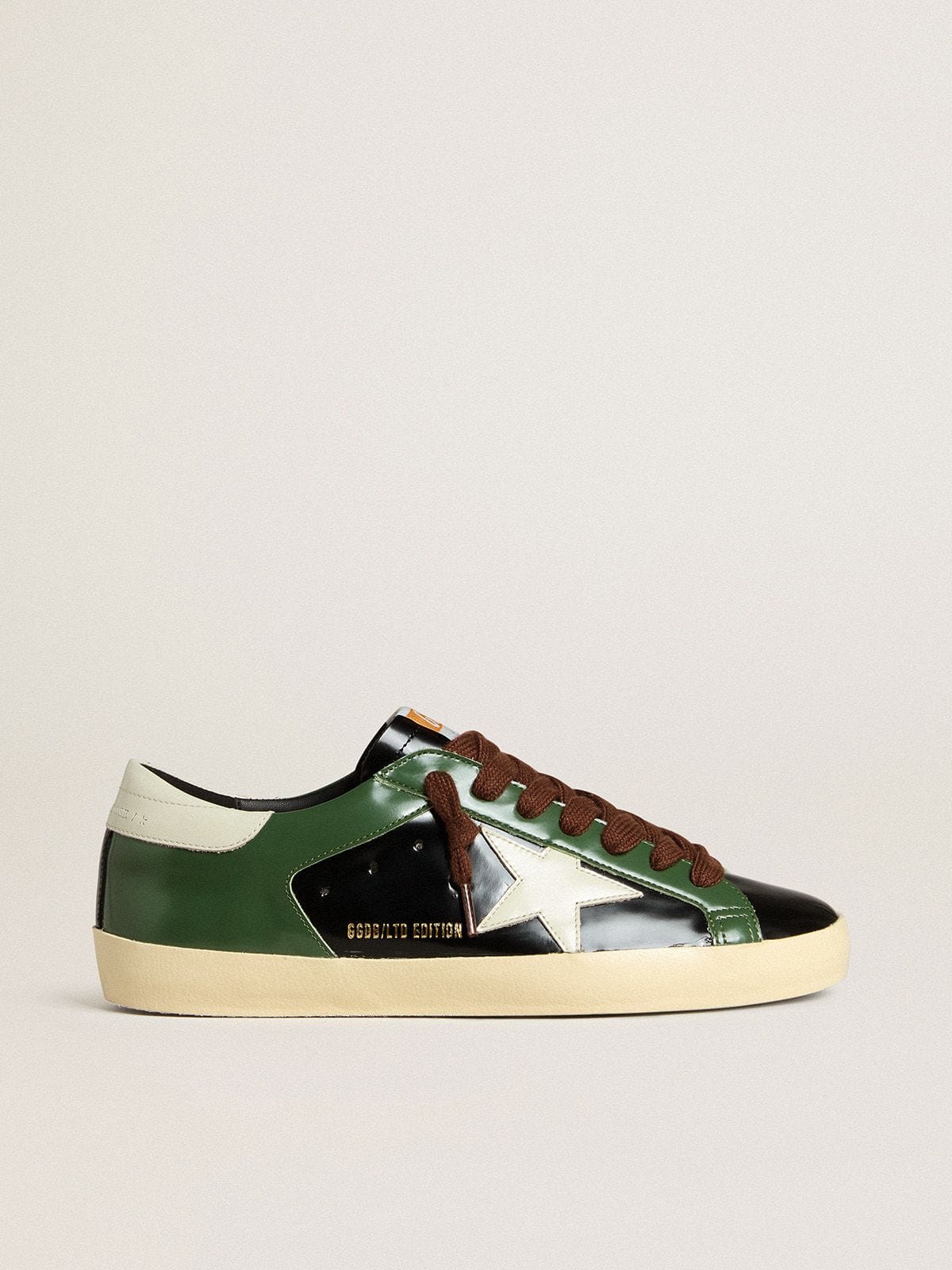 Men’s Super-Star LTD in black laminated leather with white leather star and heel tab