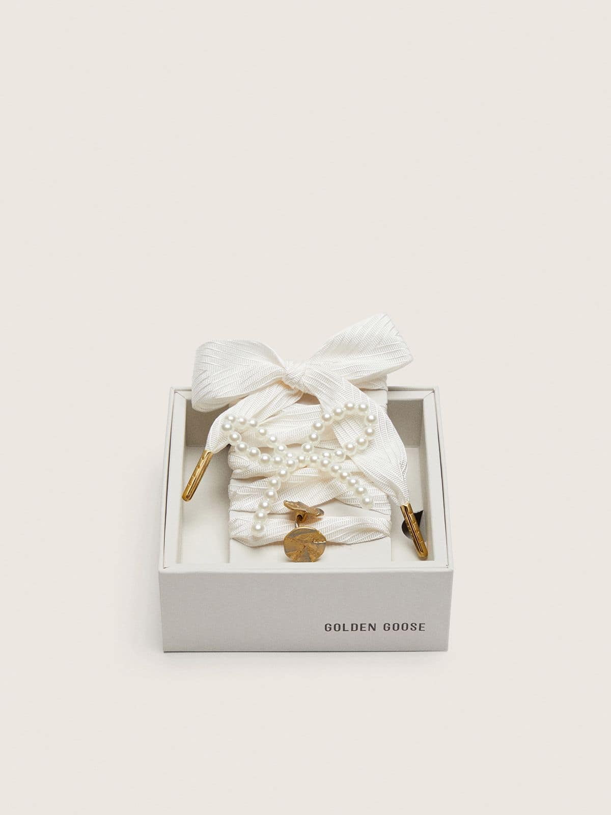 Skins "Sparkling" cream striped laces embellished with beaded charm and golden charm