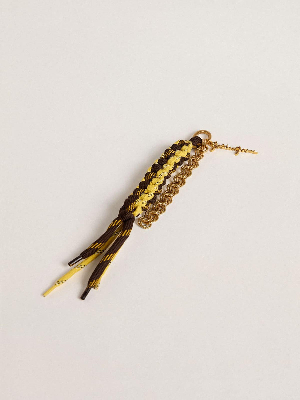 Charm with yellow and brown knotted hiking laces with chain