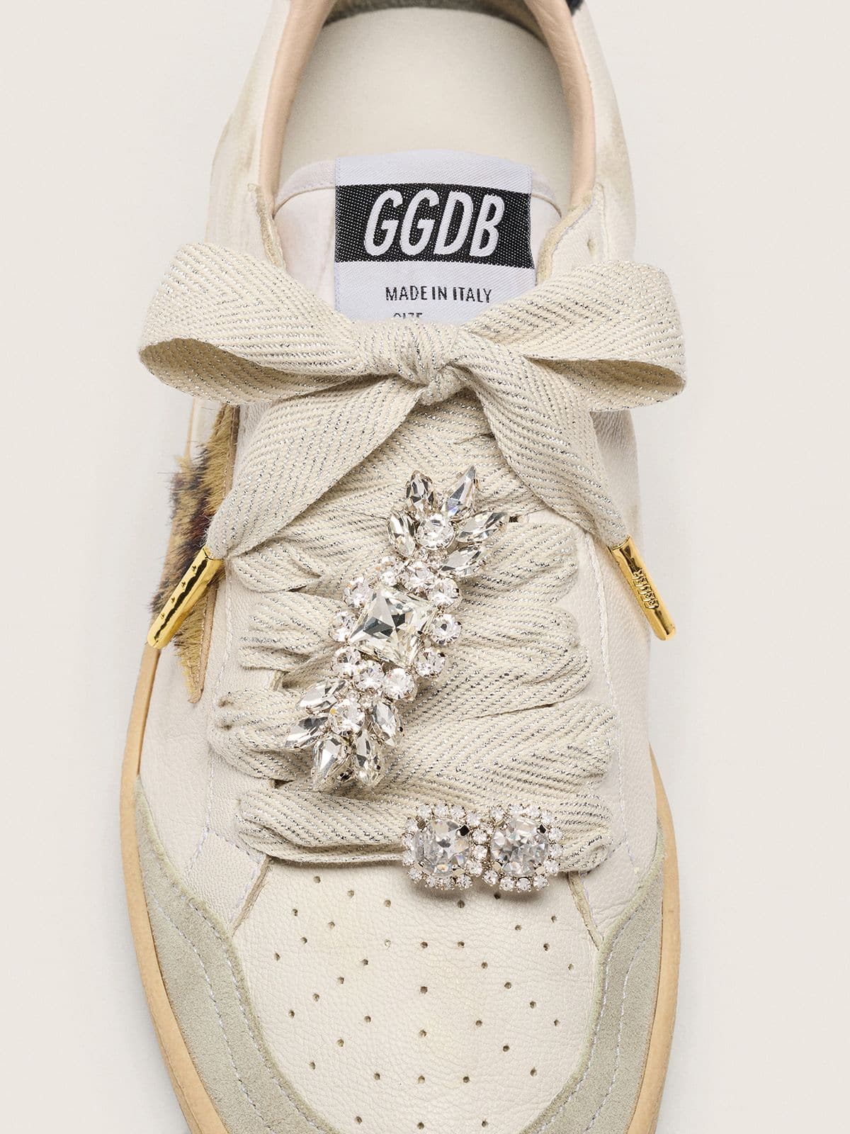 Skins "Sparkling" cream and silver herringbone laces embellished with two charms