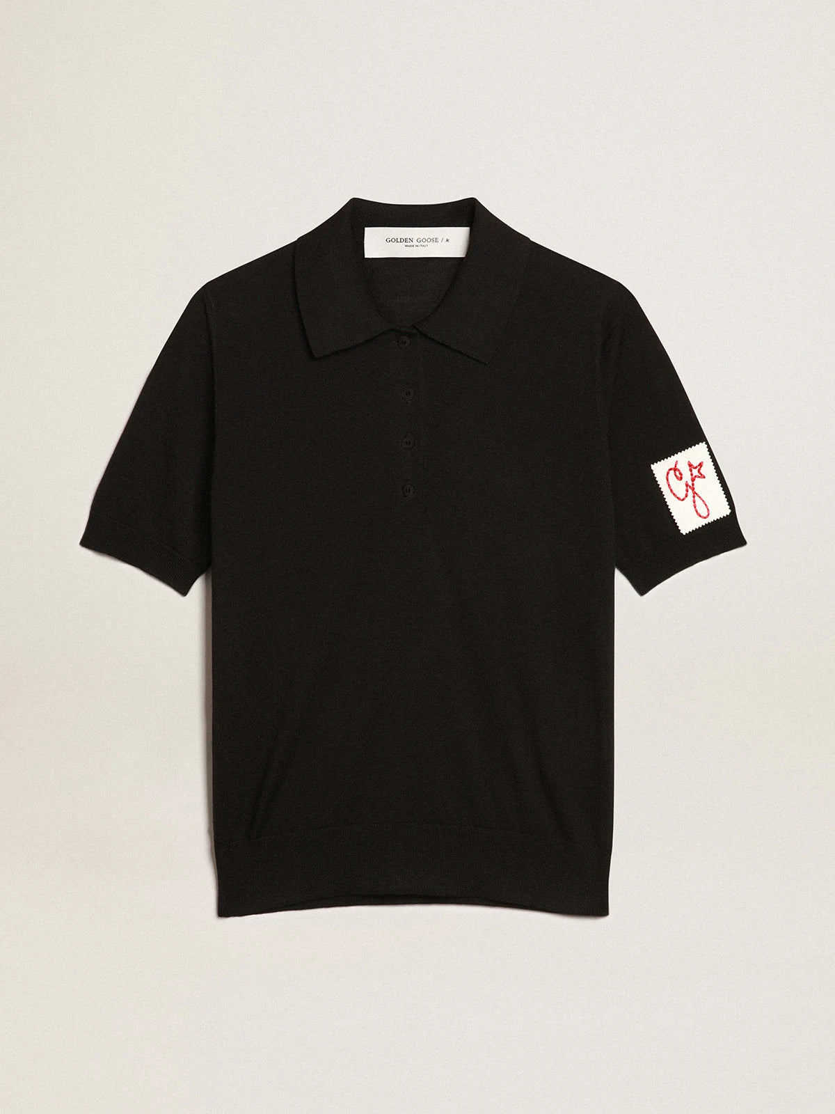 Polo da donna in lana merino di colore nero