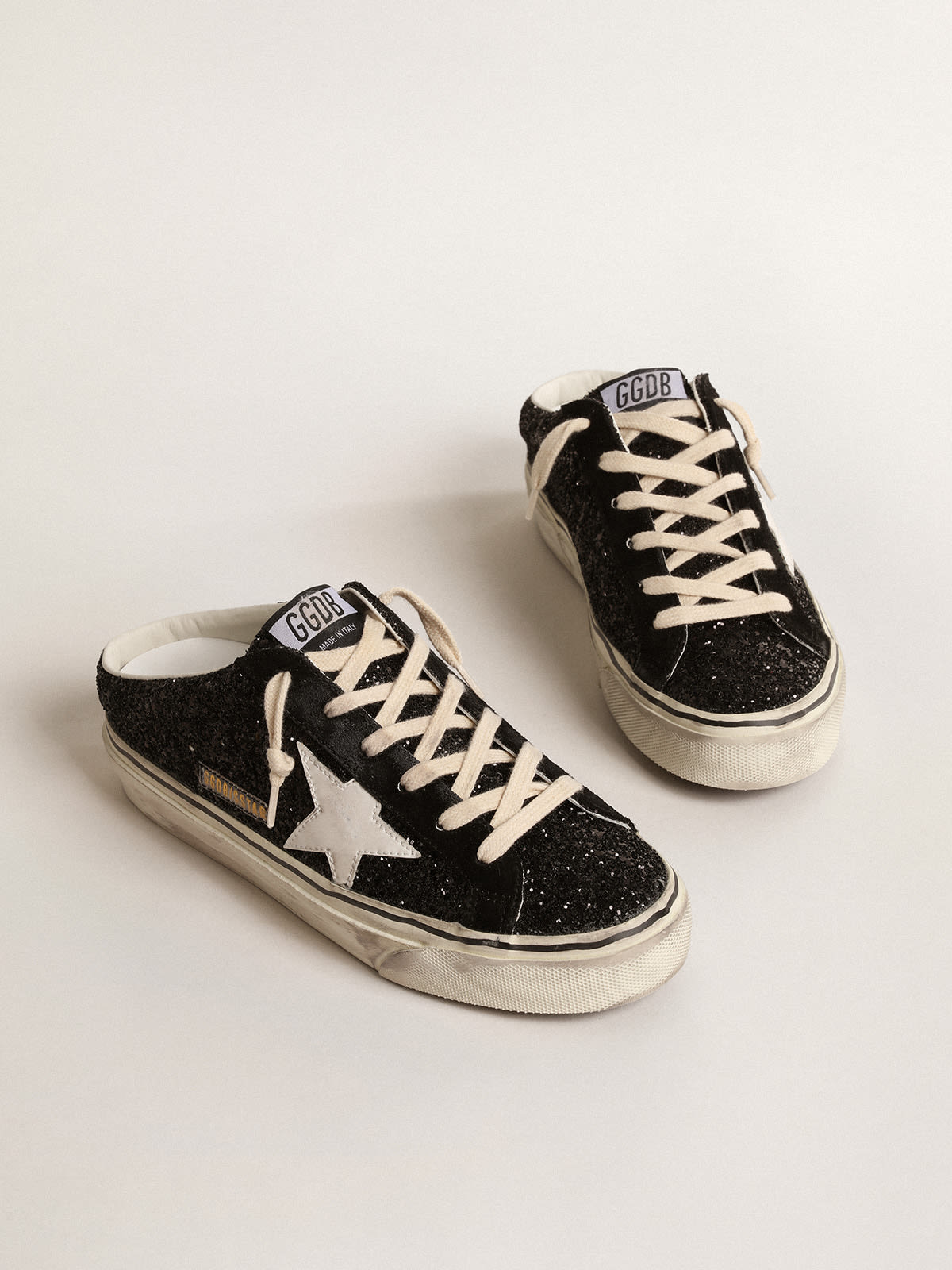 Super-Star Sabot in glitter neri con stella bio-based bianca