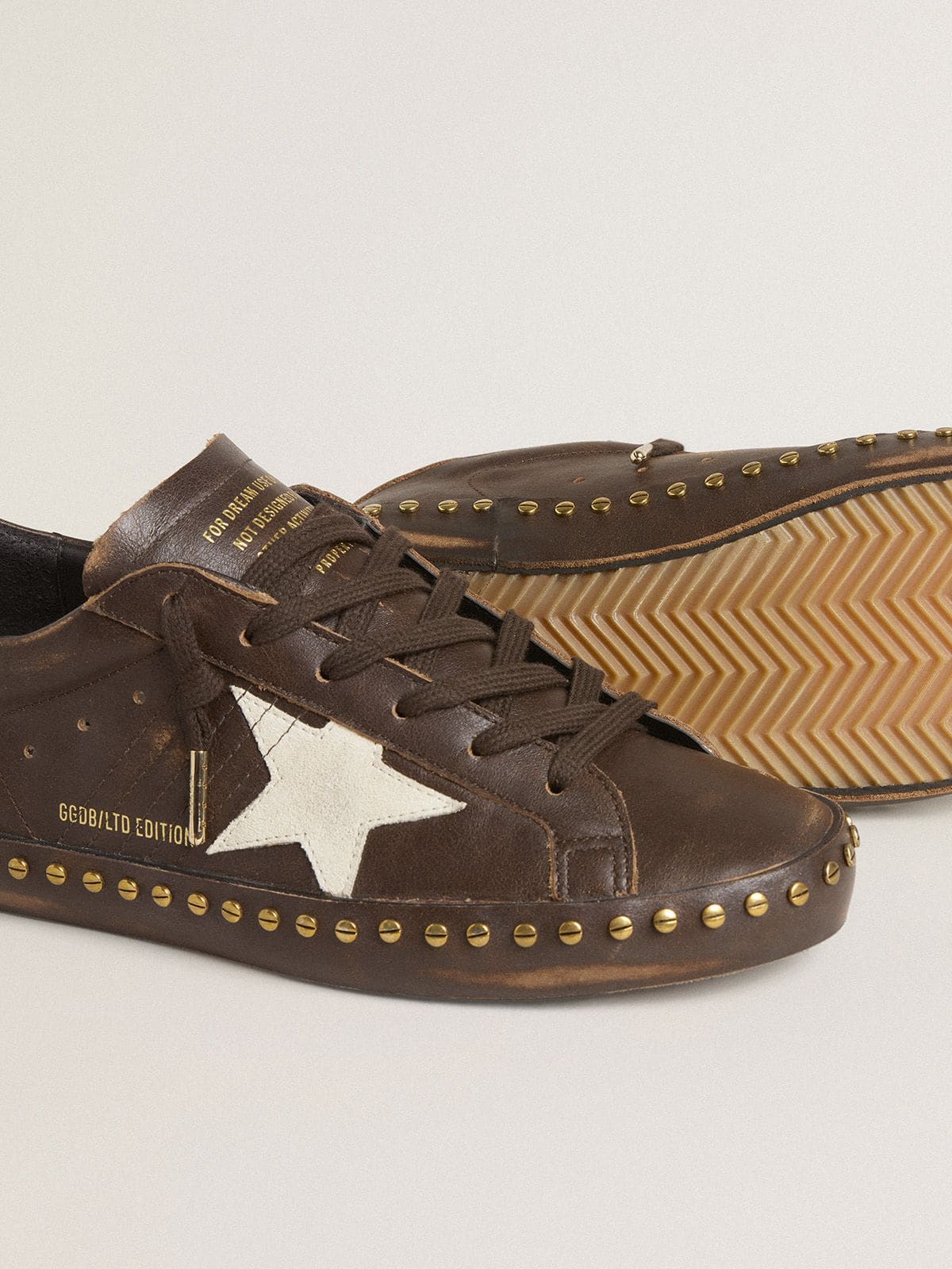 Women’s Super-Star in dark brown leather with cream suede star and studs